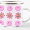 a mug with pink and white flowers and smiley faces