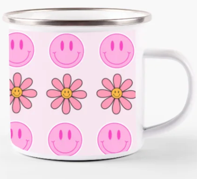 a mug with pink and white flowers and smiley faces