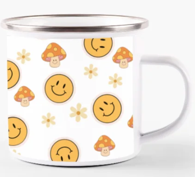 a mug with smiley faces and mushrooms